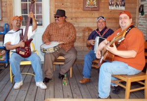 The Texmaniacs have fun with their conjunto tejano music on audio engineer Joe Treviño's back porch in San Antonio, Texas. Max Baca (right), on the bajo sexto guitar, says conjunto began with its early pioneers "listening to the German oompah music on the radio in the late 1920s. They would imitate, but in doing so they created their own sound." (Photo by Daniel Sheehy)