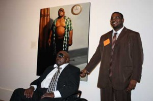 Stanley Rayfield, standing, with his father, the subject of the second prize winner, "Dad." (Photo by Warren Perry)