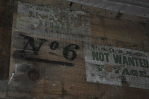 Edward Shackleton's signature (above the stenciled No. 6) above his bunk at Cape Royd. (Photo by Tom Peterson)