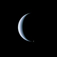Dual crescent view of Neptune and its moon Triton