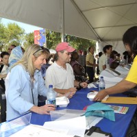 Tamsen Dewitt and Dan Mickle of the National Zoo visit one of the information tables in the Congress of Scholars tent.