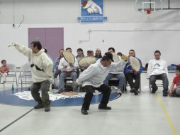 Men reenact a hunt in a traditional Siberian Yupik dance. (Photo by John Henry Pepper)