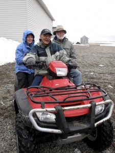 Anne and Wayne Clough get a ride on one of the ubiquitous All-Terrain Vehicles used as transportation in Gambell. (Photo by John Pepper Henry)