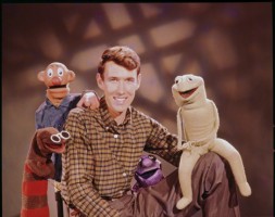 Jim Henson poses with characters from the TV show “Sam and Friends,” ca. 1956/57. Left to right: Harry the Hipster, Sam, Jim Henson, Kermit (original), Yorick. (Photo courtesy The Jim Henson Company and The Muppets Studio LLC)