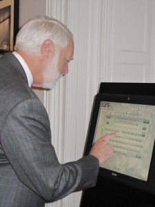 Secretary Clough signs the electronic guest book for "Elvis at 21." (Photo by Kemble Dycus)