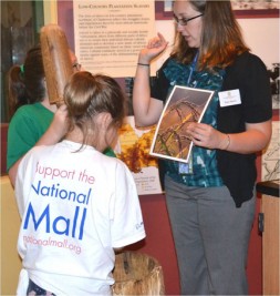 Katie March talks with visitors at the hands-on history cart.