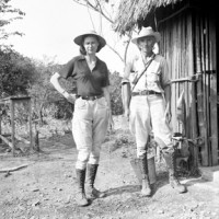 Then: Matthew W. and Marion I. Stirling at Boca San Miguel, Veracruz, Mexico, on 15 April 1939, dressed in field clothes, are standing outside a building with a wall made of horizontal boards and a thatched roof. Matthew Stirling was director of the Bureau of American Ethnology at the Smithsonian Institution. They are there to conduct anthropological field work at Veracruz, Mexico. Alexander Wetmore collected bird specimens for the United States National Museum in Mexico in 1939. He briefly joined Stirling in Veracruz, where the Stirlings were doing anthropological field work. (Photo by Alexander Wetmore)
