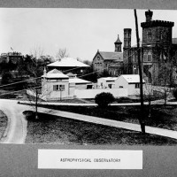 Then: The Astrophysical Observatory was established in1890 in a wooden shed built on the grounds south of the Smithsonian Institution Building. The Observatory will subsequently be enlarged, and three other smaller structures will be added between 1893 and 1898, all enclosed by a fence. This photo by an unknown photographer shows the modest facilities in 1899.