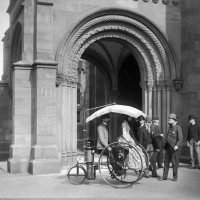 Then: This photo, from about 1888, shows the Copeland steam-propelled tricycle in front of the Smithsonian building on the Mall. The driver of the tricycle is its inventor, Lucius D. Copeland; the passenger is Frances Benjamin Johnston, who later became a noted Washington photographer. Standing to the left are patent attorney B.C. Poole and an associate, and the builder and promoter of the tricycle, Sandford Northrop. To the right are E. H. Hawley of the Smithsonian, W.H. Travis and J. Elfreth Watkins, curator of the transportation section in the Smithsonian’s U.S. National Museum, 1885-1903. (Photographer unknown)