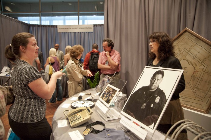 People at table displaying artifacts