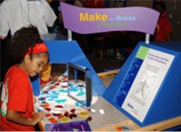 A youngster experiments with the Tessellations puzzle at The Lemelson Center’s Invention at Play exhibition.