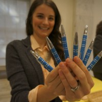 Sarah Taylor Sulick holds a bouquet of souvenir pens.