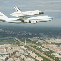 Space shuttle Discovery, mounted atop a NASA 747 Shuttle Carrier Aircraft (SCA), flies over the Washington skyline as seen from a NASA T-38 aircraft, Tuesday, April 17, 2012. (Photo by NASA/Robert Markowitz)