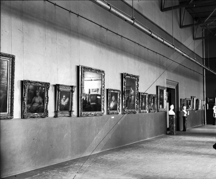 Harriet Lane Johnston Collection exhibited at the National Gallery of Art, now the National Museum of American Art, in the Lecture Hall of the Arts and Industries Building in November of 1906, before it had been entirely remodeled. Photo shows 13 paintings, several busts on pedestals, and a statuette on a floor stand. The Gallery first opened to the public on November 24, 1906