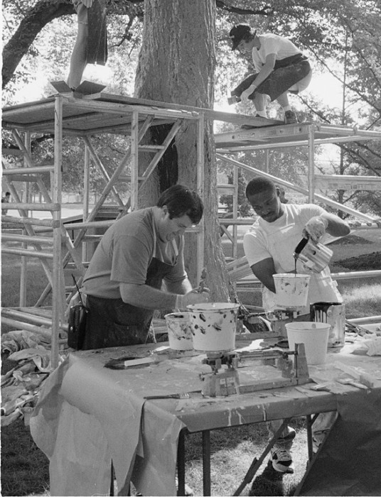 Office of Exhibits Central Modelmakers Paul Rymer, top left, and Carolyn Thome, top right, work on a mold to be cast into a beehive for the new Orkin Insect Zoo as Natural History Exhibits staffers Robert Gibson, left, and Anthony Bowden mix up the resin. (Photo by Laurie Minor-Penland, as featured in the Torch, November 1992) 