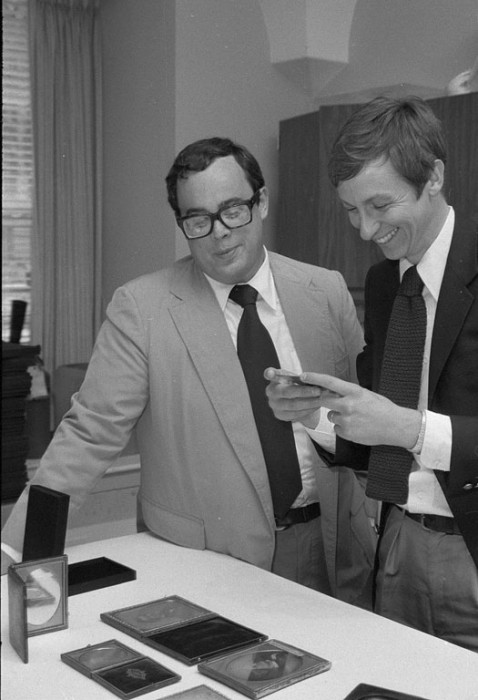 Harold Pfister, program management officer in charge of the National Portrait Gallery's exhibit "Facing the Light: Historic American Portrait Daguerreotypes," and William F. Stapp, NPG's curator of photographs, examine some of the pieces featured in the exhibition. (As featured in the Torch, September 1978)