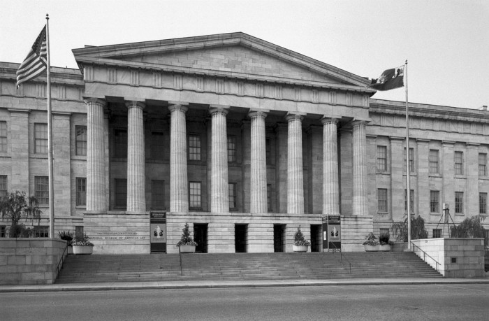 The National Collection of Fine Arts, now known as the Smithsonian American Art Museum, is located on this side of the Old Patent Office Building at 8th and G Streets, N.W. The National Portrait Gallery is located on the opposite side (not shown in photograph). The Old Patent Office building is a Greek Revival structure, built (1836-1866) by Robert Mills and became home to the National Collection of Fine Arts in 1968. In 1980, NCFA was renamed the National Museum of American Art, and then in 2000 it became known as the Smithsonian American Art Museum.
