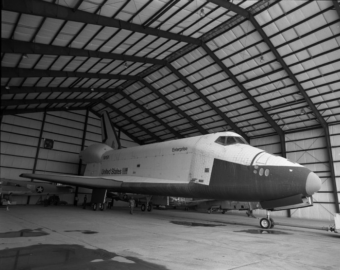 The space shuttle Enterprise inside a hangar at Dulles International Airport (July 1988) as featured in the Torch, September 1988. (Photo by Mark Avino)