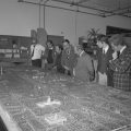Unveiling of the model for the exhibition "The Federal City: Plans and Realities" in the Office of Exhibits Central workshop. Pictured are (from left) John Singleton, model maker; John Widener, Exhibits Central; Paul Perrot, Assistant Secretary for Museum Programs; Charles Conrad, Director of the National Capital Planning Commission; Wilcomb Washburn, curator of the exhibition and Director of the Office of American Studies; Charles Atherton, Secretary of the Commission of Fine Arts; Samuel Fraser, National Capital Planning Commission; and Donald Myers, Commission of Fine Arts. Photo by unknown photographer, as featured in the Torch, March 1976