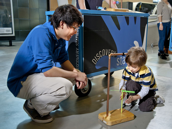 A young visitor explores the properties of a whirlygig at one of the Air and Space Museum's Discovery Stations.