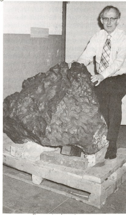 Curator Roy S. Clarke, Jr., poses with the Old Woman Mountains meteorite. Photo by Richard Hofmeister, as featured in the Torch, March 1978.