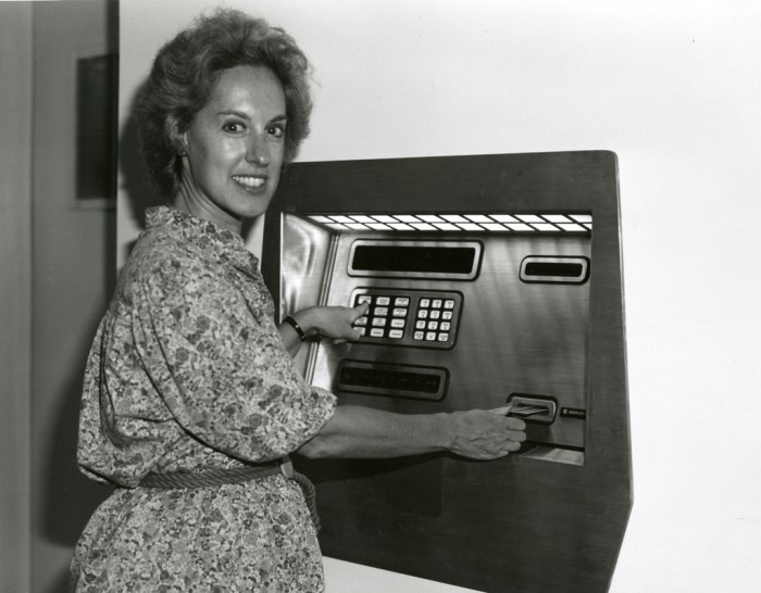 Ann Leven uses the first ATM machine at the Air and Space Museum