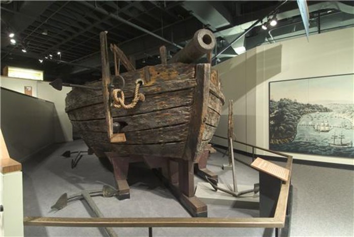 Image of the Gunboat "Philadelphia" on display in the National Museum of American History. The American gunboat "Philadelphia" sank into Lake Champlain in October 1776, during a naval battle against the British in the American Revolution. Visible is the 12 pounder gun mounted at the bow. She was raised in 1935 with much of its equipment intact and came to the Museum in 1964, complete with the 24-pound ball that sent the gunboat to the bottom