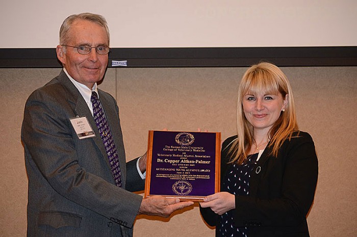 Dr. Ralph C. RIchardson, dean of the College of Veterinary Medicine at the University of Kansas, presents the 2013 Outstanding Young Alumnus Award to Dr. Copper Aitken-Palmer.