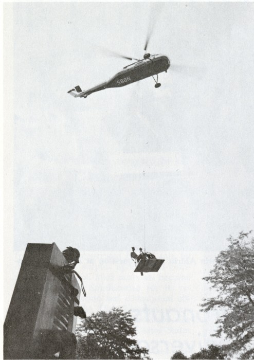 At the Hirshhorn home in Greenwich, Connecticut, a helicopter lifts Henry Moore's "King and Queen." In the foreground is "Man Pushing the Door" by Jean Ipousteguy. "King and Queen" was delivered to the Hirshhorn Museum and Sculpture Garden on August 5, 1974. 