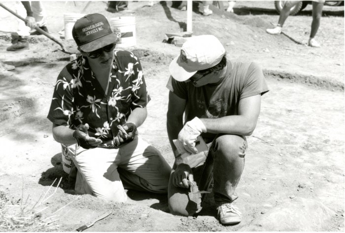 Curator Doug Owsley (left) and an archaeological dig team member examine a bone fragment unearthed at the Antietam battlefield. (Photo by Richard Strauss, as featured in the Torch, October 1998)