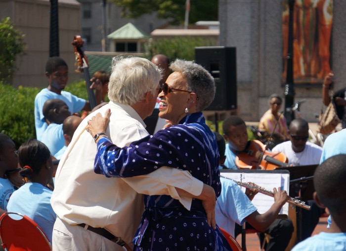 Johnnetta Besch Cole, director of the National Museum of African Art, dances to the music of the Les Petits Chanteurs Haitian Boys Choir at a free concert Sept. 13, 2013. (Photo by Brian Ireley)