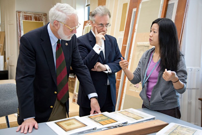 Smithsonian Secretary G. Wayne Clough, left, and Freer and Sackler Galleries Director Julian Raby, center, learn from Japanese Painting Conservator Regina Belard, right, about Asian art conservation at the museums on Aug. 8, 2008. (Photo by Ken Rahaim)