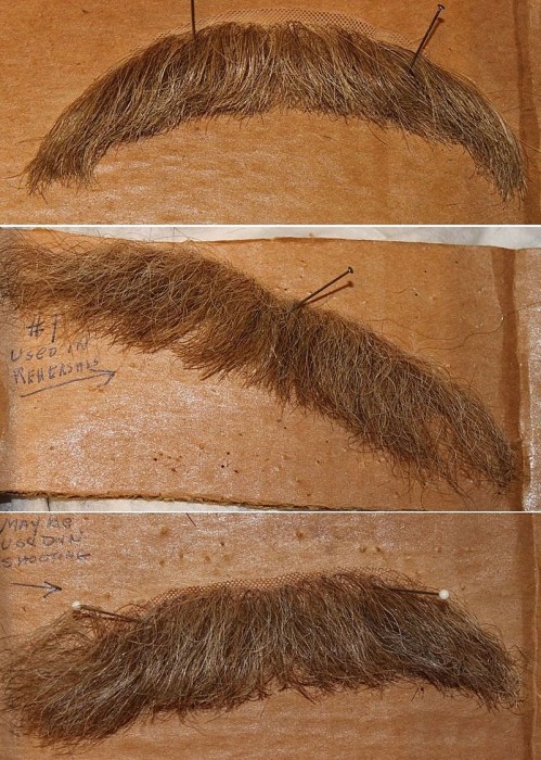 The various mustaches, ranging in hair color from auburn to gray, allowed Whitmore to visibly "age" over the course of the play.