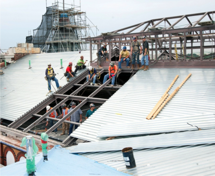 Workers replace the roof of the Arts & Industries Building. (Photo by Chris Lethbridge)