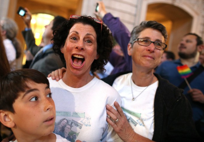 Same-sex couple Sue Rochman, center, and Robin Romdalvik with their son Maddox Rochman-Romdalvik celebrate upon hearing the U.S. Supreme Court's rulings on gay marriage in June. (Photo by Justin Sullivan/Getty Images)