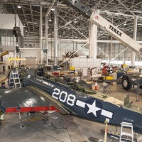 On March 4, 2014, the Curtiss SB2C-5 Helldiver’s engine is lifted by crane into place. (Photo by Dane Penland)