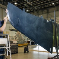 Museum specialist David Wilson prepares the tail horizontal section for painting. (Photo by Dane Penland)