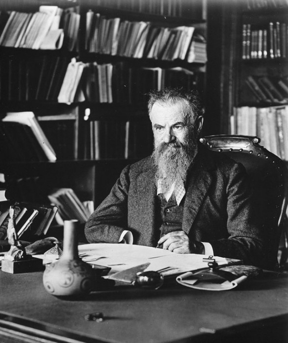 Major John Wesley Powell (1834-1902) seated at his desk in his office in the Adams Building on F Street in Washington, D.C. Following the Civil War, there were four national survey leaders. One was geologist and western explorer Powell, who led expeditions and conducted surveys of the American West. In 1869 he set out by boat to explore the Colorado River from the Green River, Wyoming Territory, to the foot of the Grand Canyon. When Congress created the Bureau of Ethnology in 1879, Powell was named its first director (1879-1902), a post he held until his death. Placed under the auspices of the Smithsonian Institution, the bureau, whose name was changed to the Bureau of American Ethnology, was to be the repository of the "archives, records, and material relating to the Indians of North America, collected by the geographical and geological survey of the Rocky Mountains"