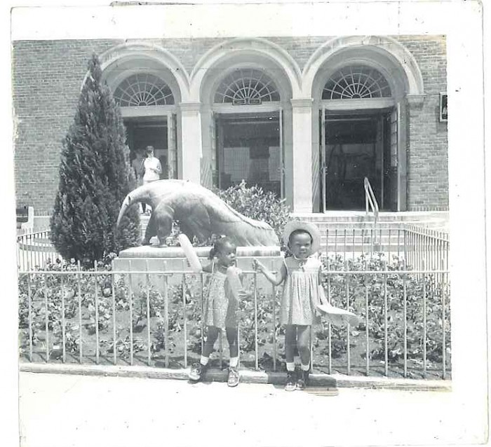 Two children standing in front of the small mammal house at the National Zoo in 1969