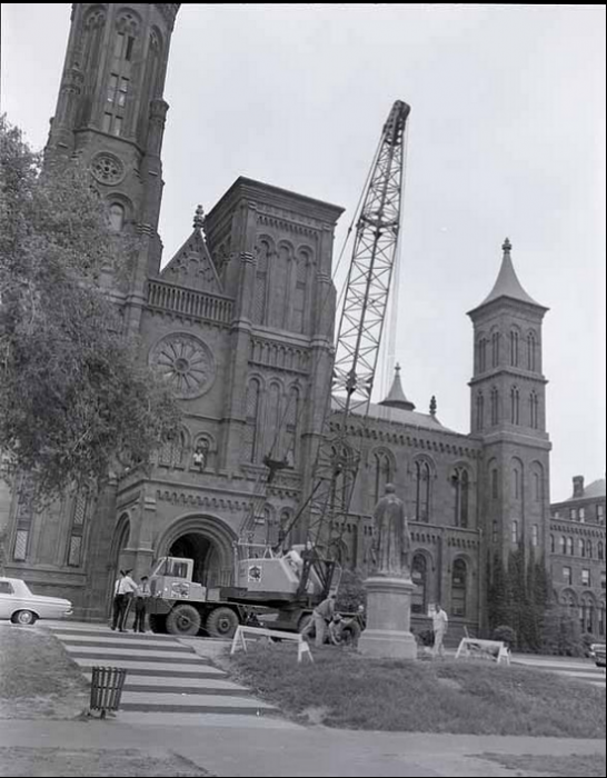 The statue originally faced the Castle. The 1965 Bicentennial Celebration of James Smithson's birth prompted a dizzying move for the Joseph Henry statue. In May of 1965 Secretary S. Dillon Ripley had the Joseph Henry statue turned around to face Smithsonian museums across the Mall so that he might look upon the legacy of his devotion to the increase and diffusion of knowledge. (Photographer unknown, via Smithsonian Institution Archives)