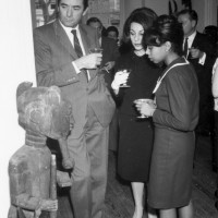 Actor Gregory Peck, Veronique Peck, and an unidentified woman admire African art at the Museum of African Art