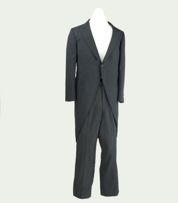 Suit with black swallowtail jacket and striped pants worn by Groucho Marx on the television program  "You Bet Your Life". Gift of Groucho Marx Estate.