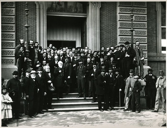 U.S. Quarter Master General staff members on the front steps of the building, 1865