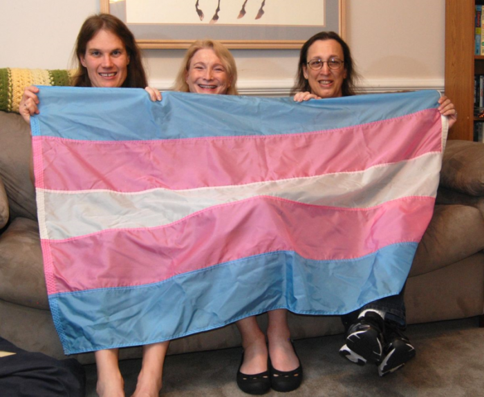 Transgender flag designed by Monica Helms (right), and friends. The flag's stripes represent the traditional pink and blue associated with girls and boys and white for intersex, transitioning, or of undefined gender. Helms served in the United States Navy and became an activist for transgender rights in the late 1990s in Arizona where she grew up. She designed the flag in 1999.