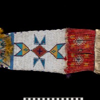 Northern Inunaina (Arapaho) pipe bag, ca. 1885, Wind River Reservation, Wyoming Hide, glass beads, porcupine quills, dye, ferrous metal cones, copper alloy disks, feathers, sinew, pigment (Photo by Ernest Amoroso)