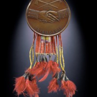 Thomas Jefferson peace medal, 1801, owned by Powder Face (Northern Inunaina / Arapaho), Oklahoma Bronze Copper alloy, hide, porcupine quills, feathers, dye, metal cones (Photo by Walter Larrimore)