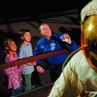 Young visitors to the National Air and Space Museum learn about space travel from an actual astronaut. (Photo by Eric Long)