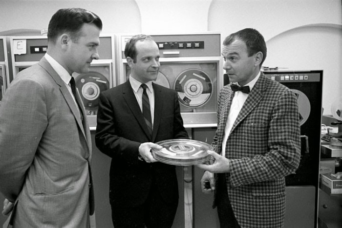 Nicholas Suszynski, Director of Sl's Information Systems Division, Reginald Creighton, senior systems analyst for the MNH computer project, and Dr. Donald Squires, Deputy Director of the Museum of Natural History, with a computer tape containing scientific data, 1968. Acc. No. 11-008, Smithsonian Institution Archives.