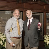 When photographer Eric Long (left) received his 30-year pin from Secretary Clough, Dr. Clough joked that he had almost six years of service but had no pin to show for it. Eric modified his own 20-year pin and presented it to the Secretary Dec. 8 for his six years of service to the Smithsonian.