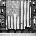 The Star Spangled Banner hanging from the exterior of the Smithsonian Institution Building in 1914, shortly after it was aquired for the National Museum.
